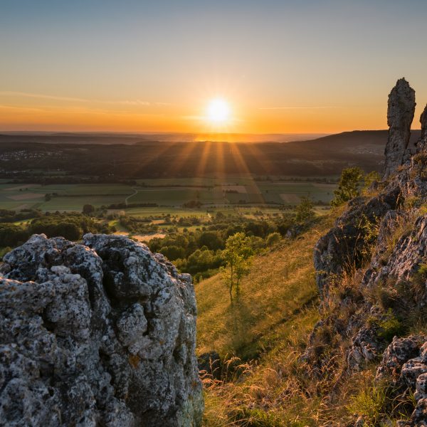 a sunset over a valley