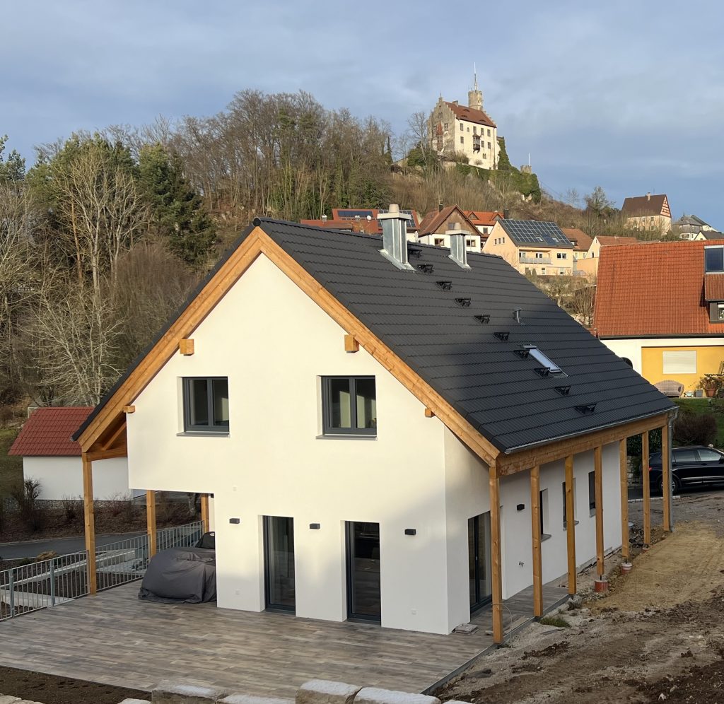 a house with a fence and a road in the background