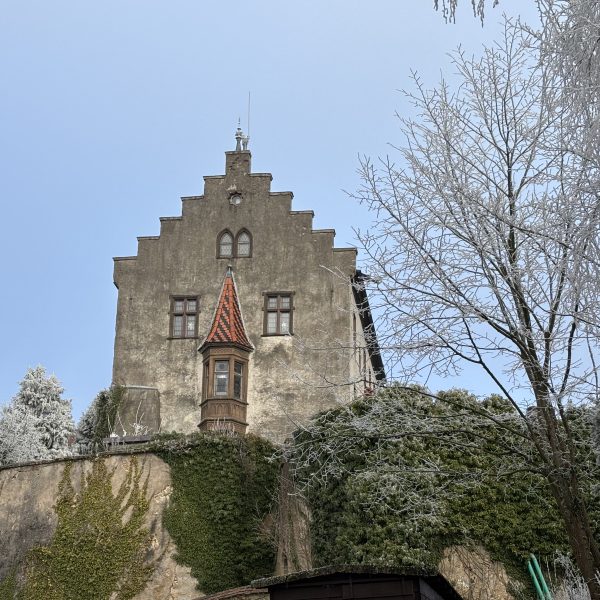 a stone building with a red roof